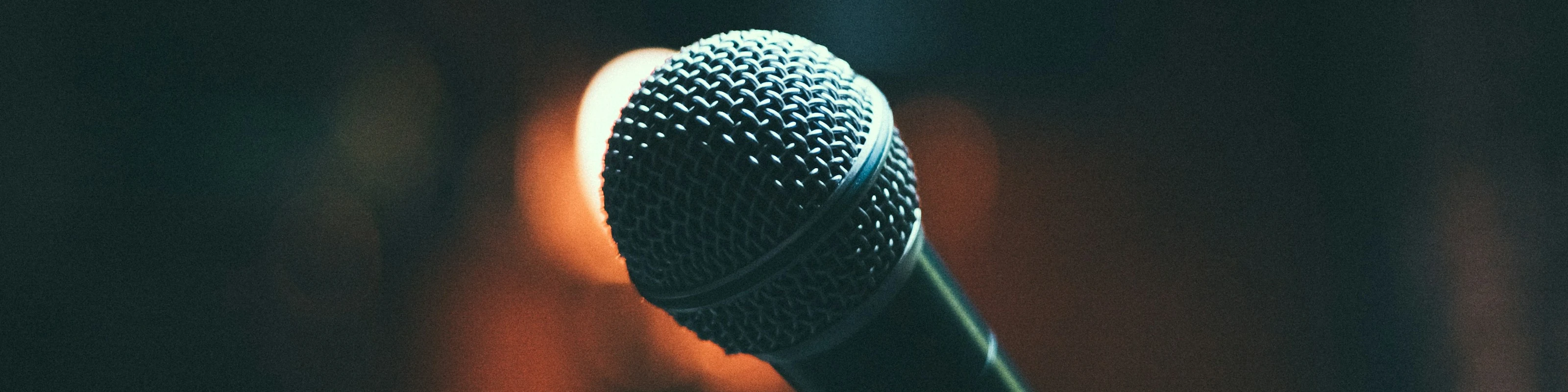 Illustrative microphone photograph; not a photograph of Bricktown Comedy Club